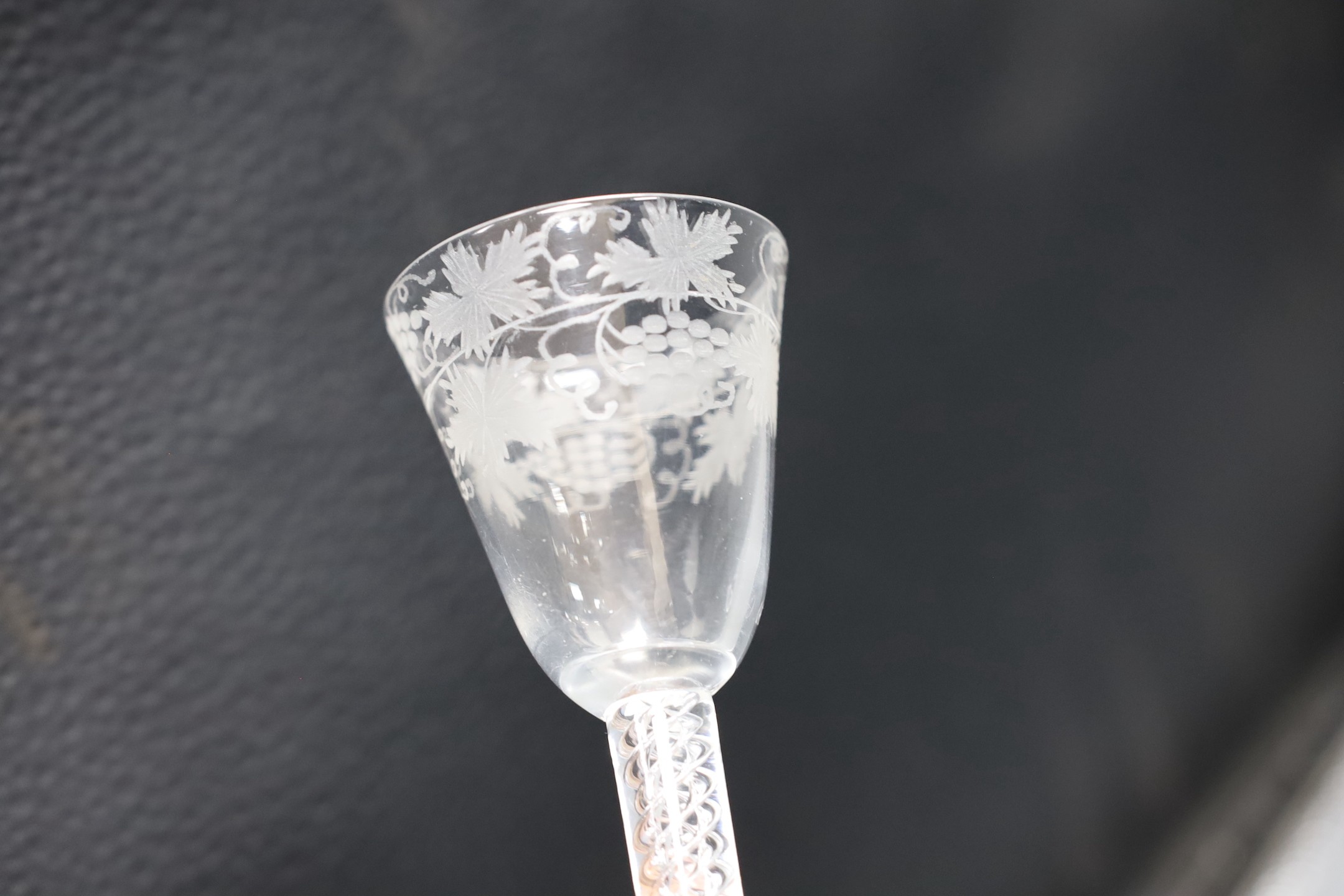 An 18th century engraved air twist stem wine glass, 15cm tall